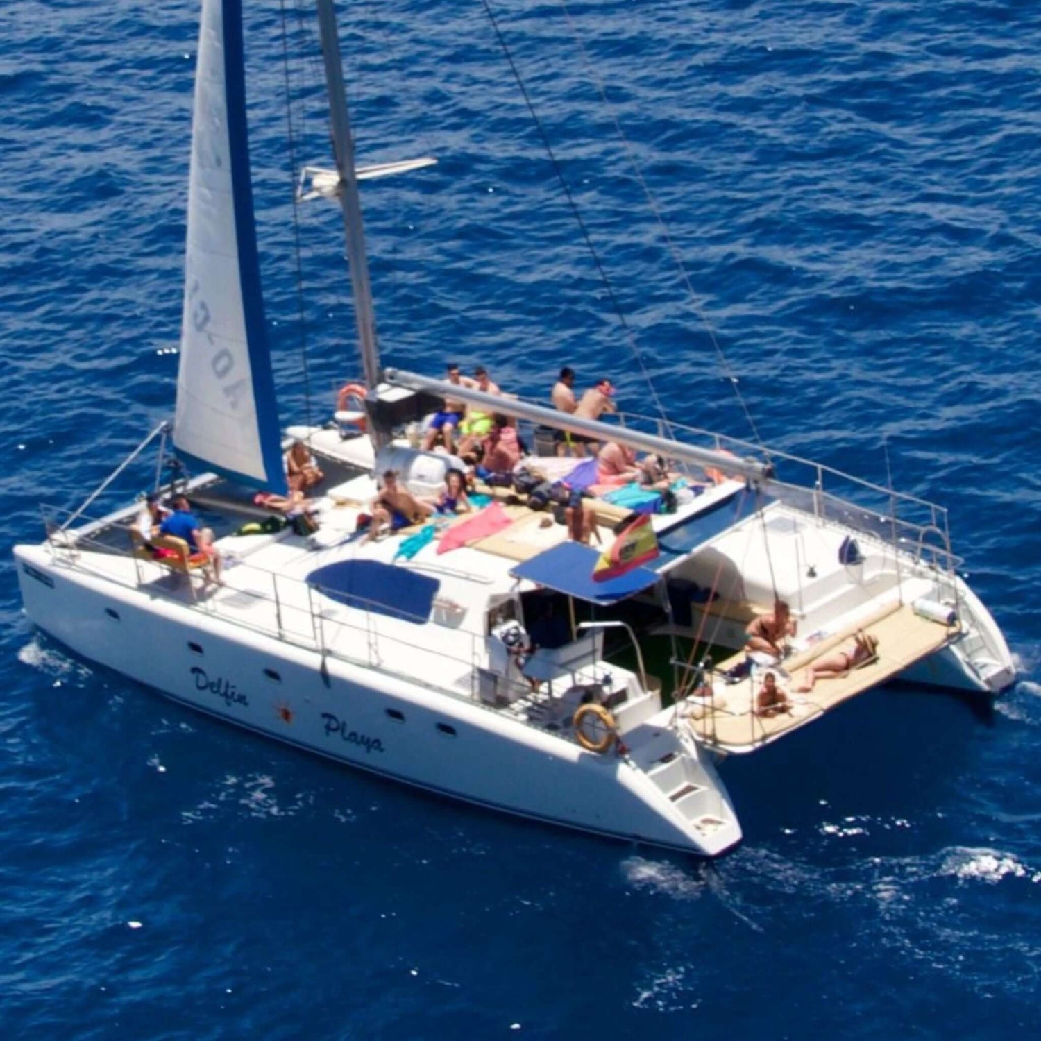 catamaran trips - people sunbathing on the delfin playa catamaran 