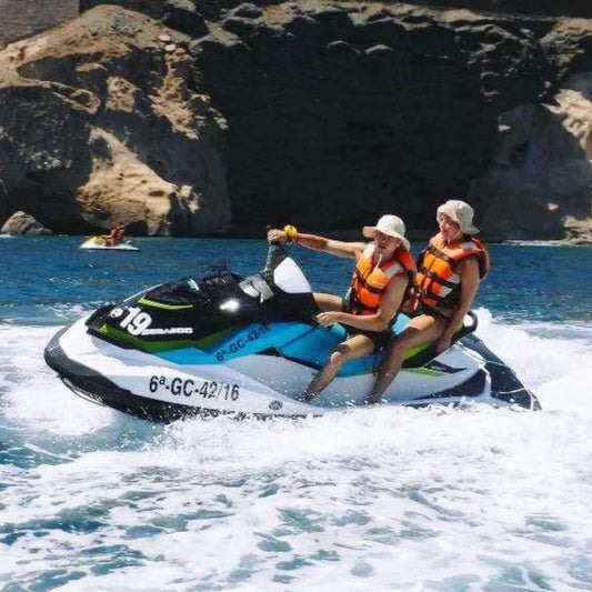 jet ski rental gran canaria couple driving a jet ski in front of the caves