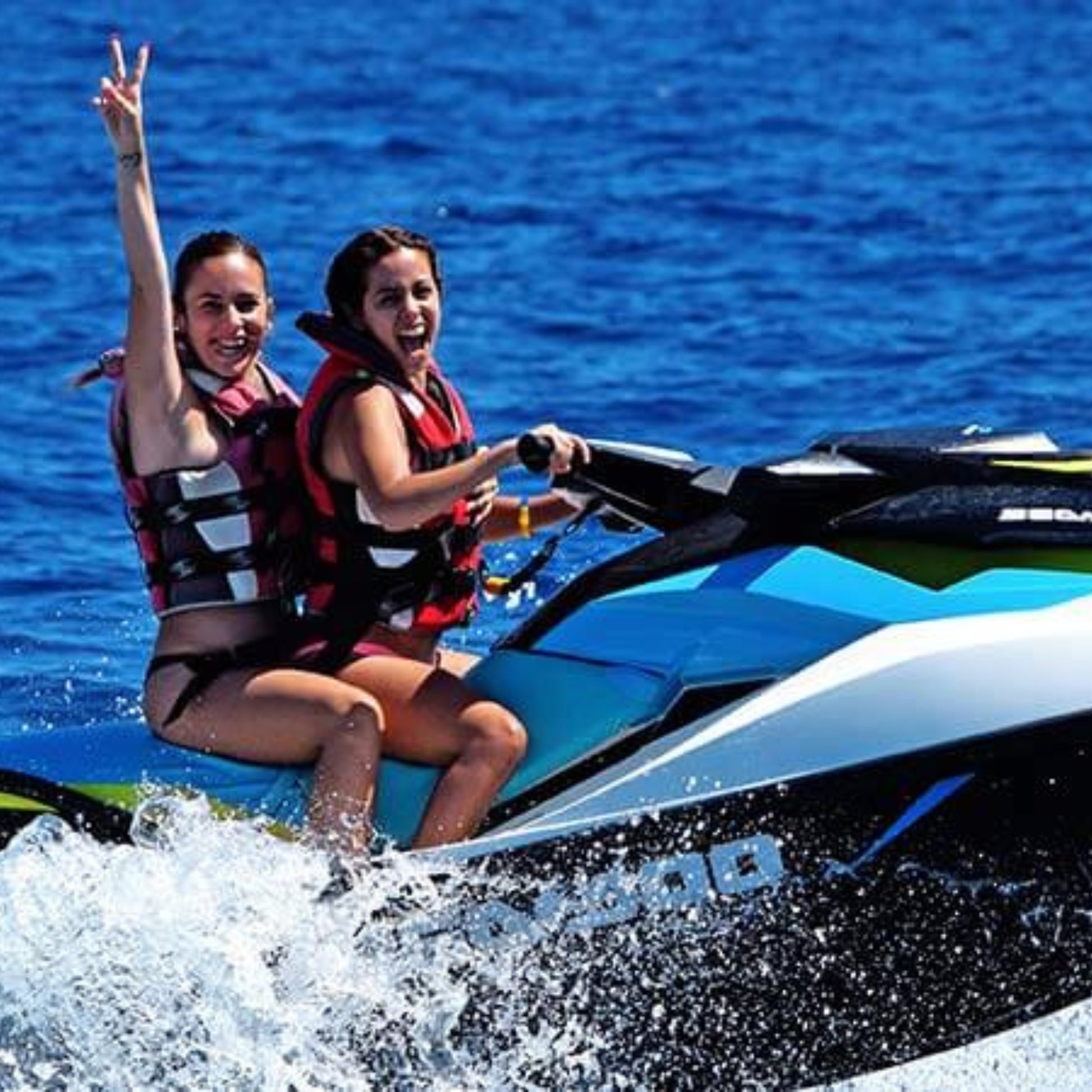 jet ski safari gran canaria - water sports - 2 girls smiling while riding a jet ski