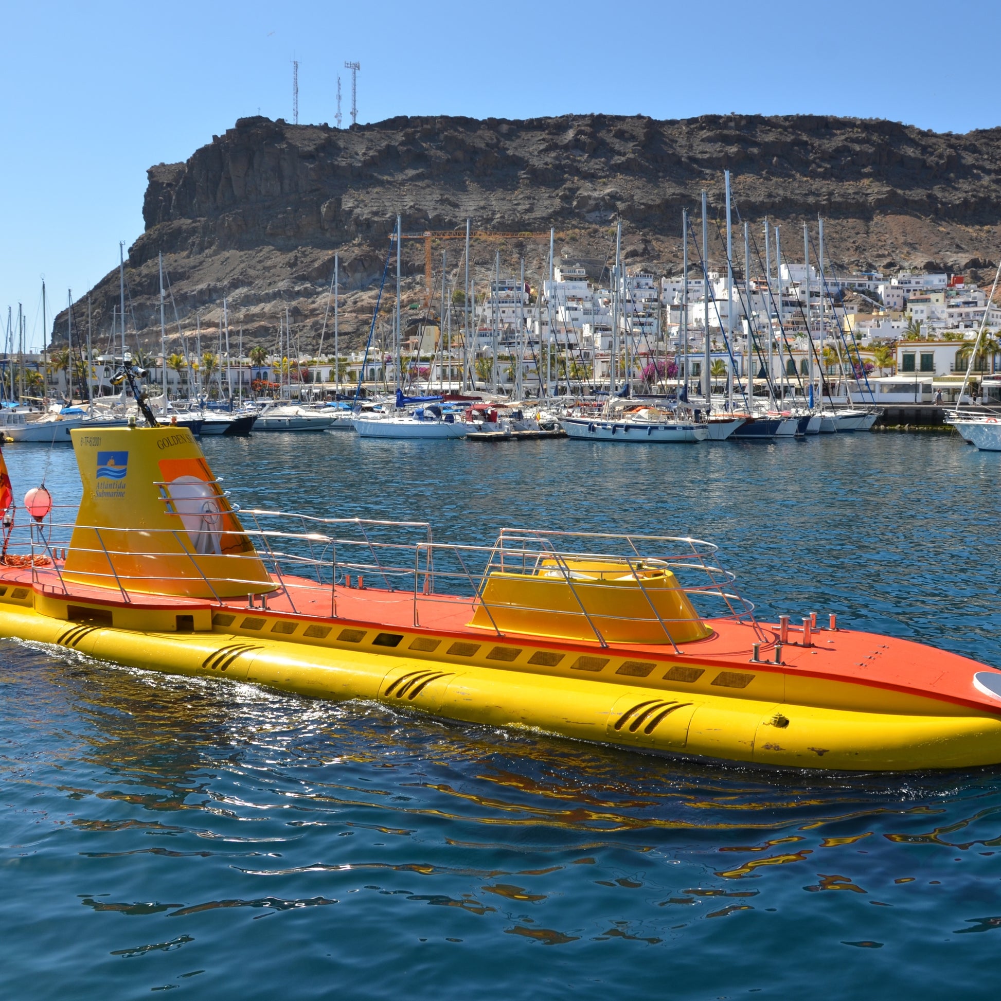 the yellow submarine is preparing to dive in front of puerto de mogan